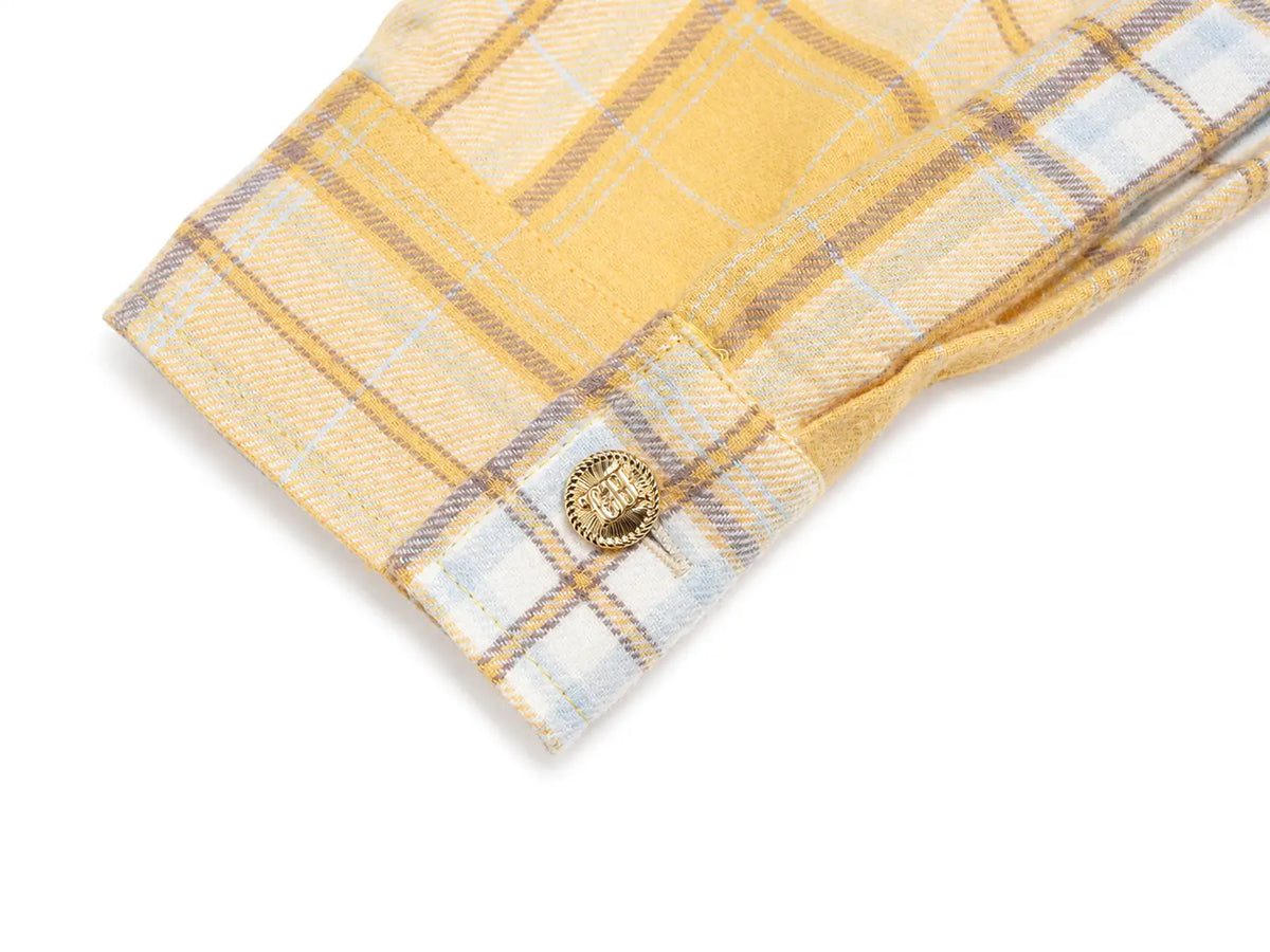 Close-up of a yellow plaid shirt cuff with a decorative gold button, set against a plain white background. TCH Yellow Plaid Embroidered Cross Shirt