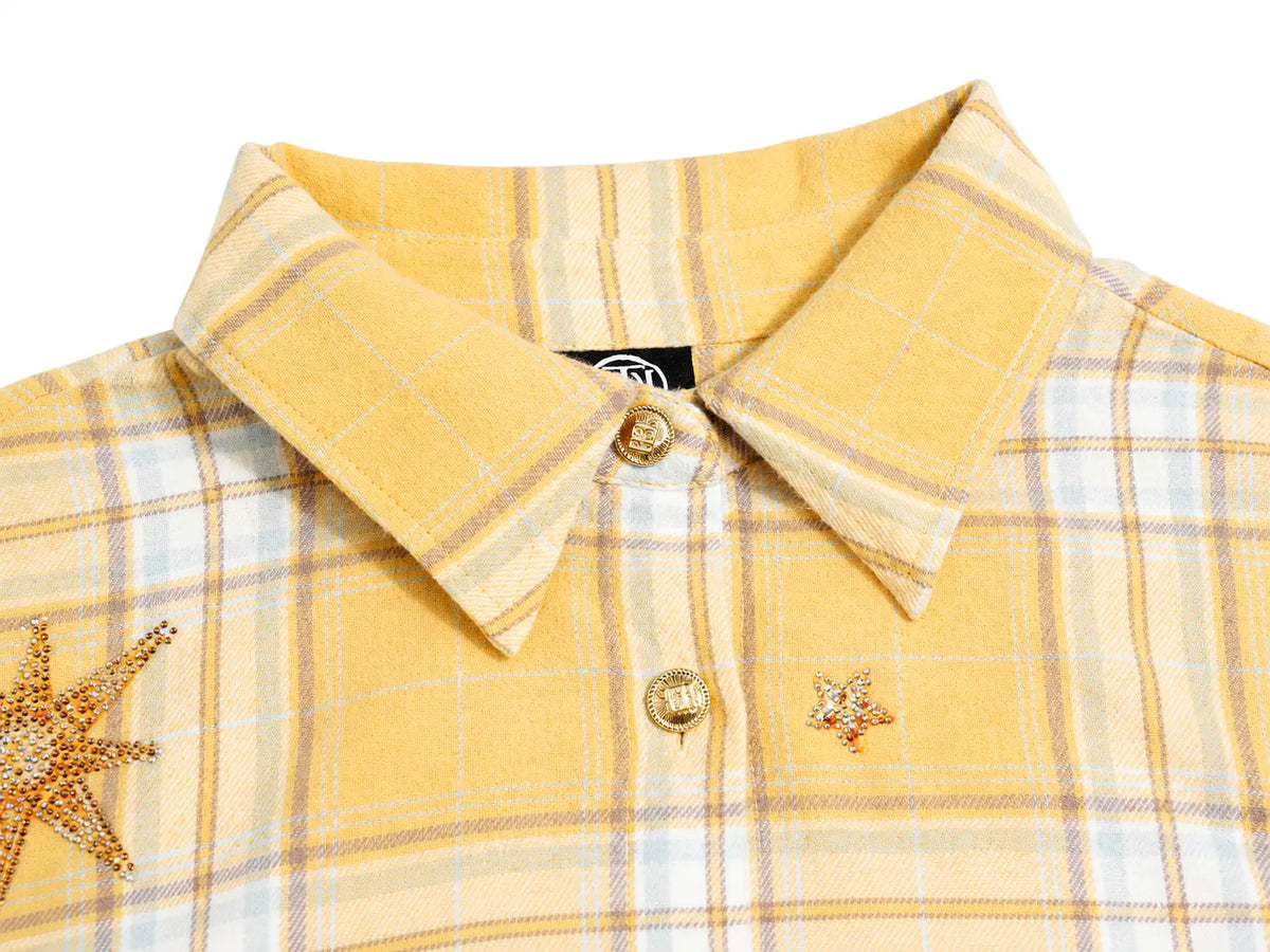 A close-up of a yellow plaid button-down shirt with star-shaped crystal embellishments on the chest, featuring a pointed collar and gold-tone buttons. TCH Yellow Plaid Embroidered Cross Shirt
