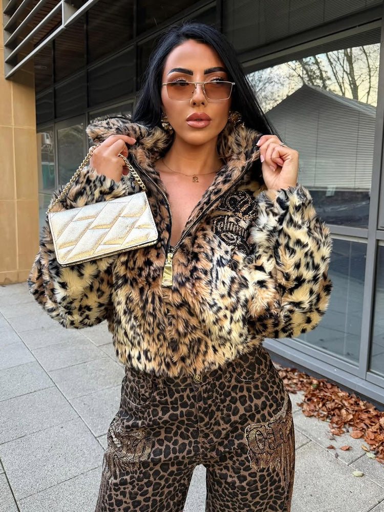 Person wearing a leopard print outfit with a matching handbag outdoors.